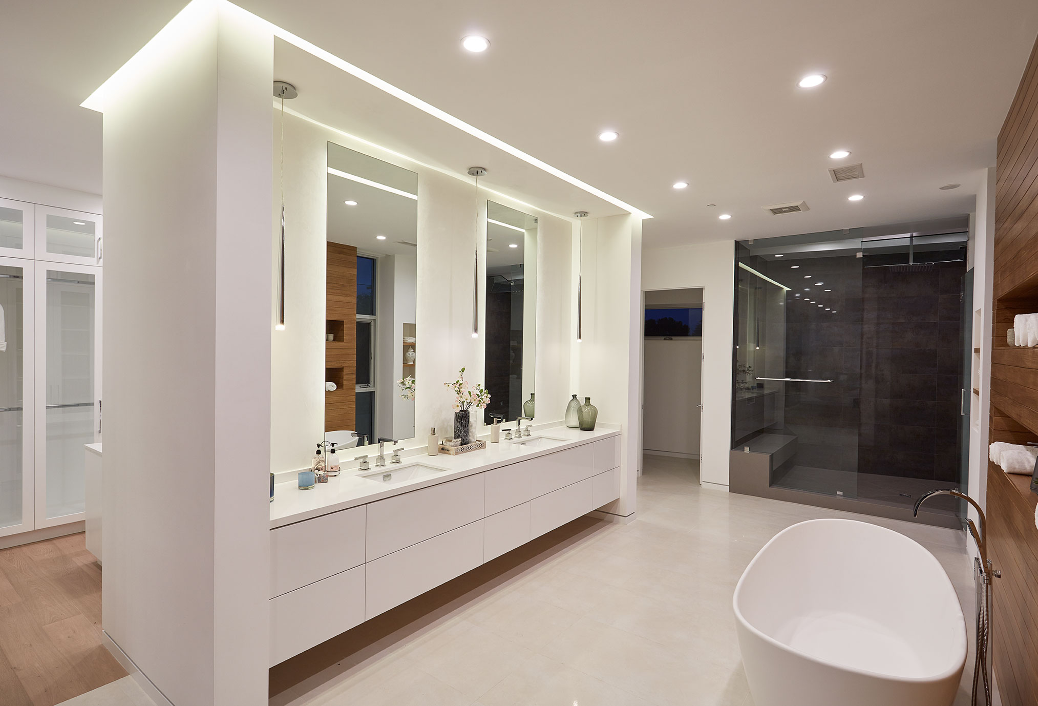 A white colored bathtub and custom glass mirrors