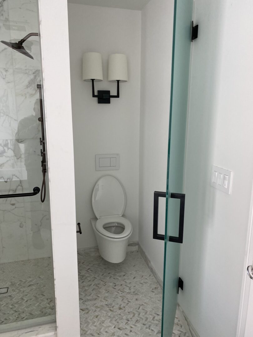 Wall mounted toilet and the twin lights inside the washroom