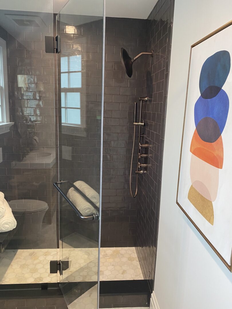 bronze shower fixtures on the black colored tile wall