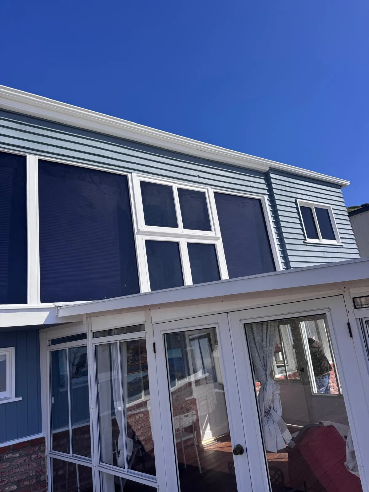 Sunlit exterior of a blue home