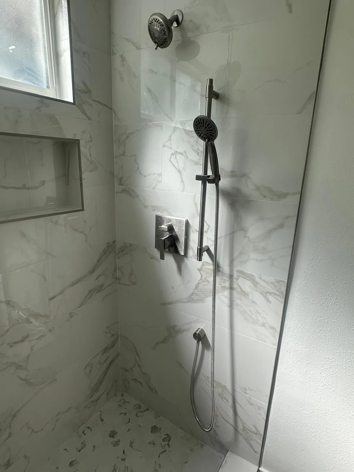 Modern shower with marble walls
