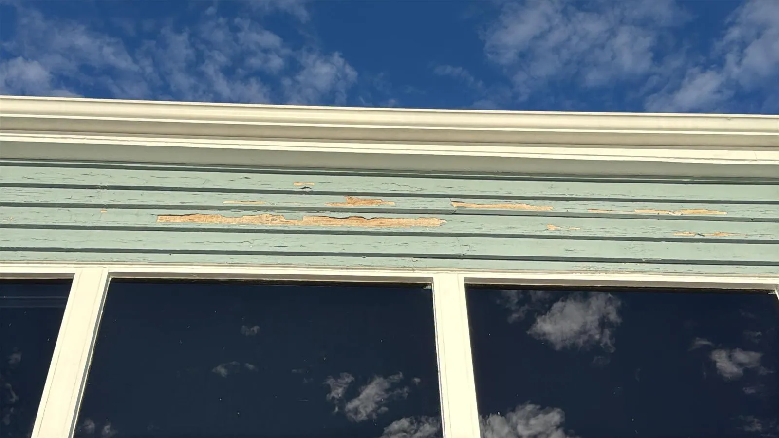 Weathered house siding with peeling paint