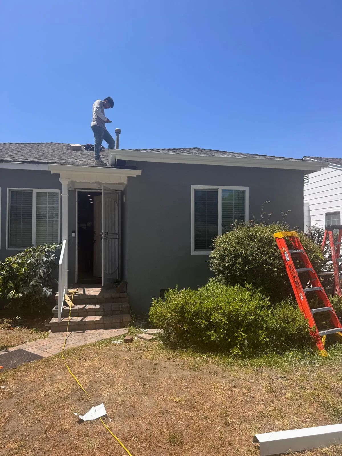 Person working on house roof