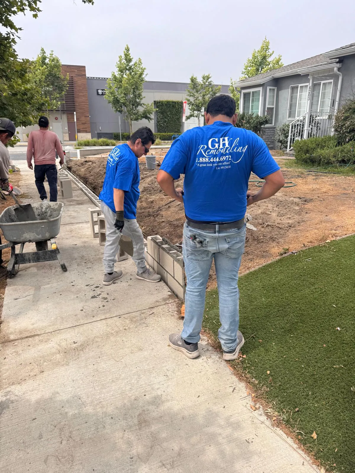 Workers constructing garden wall