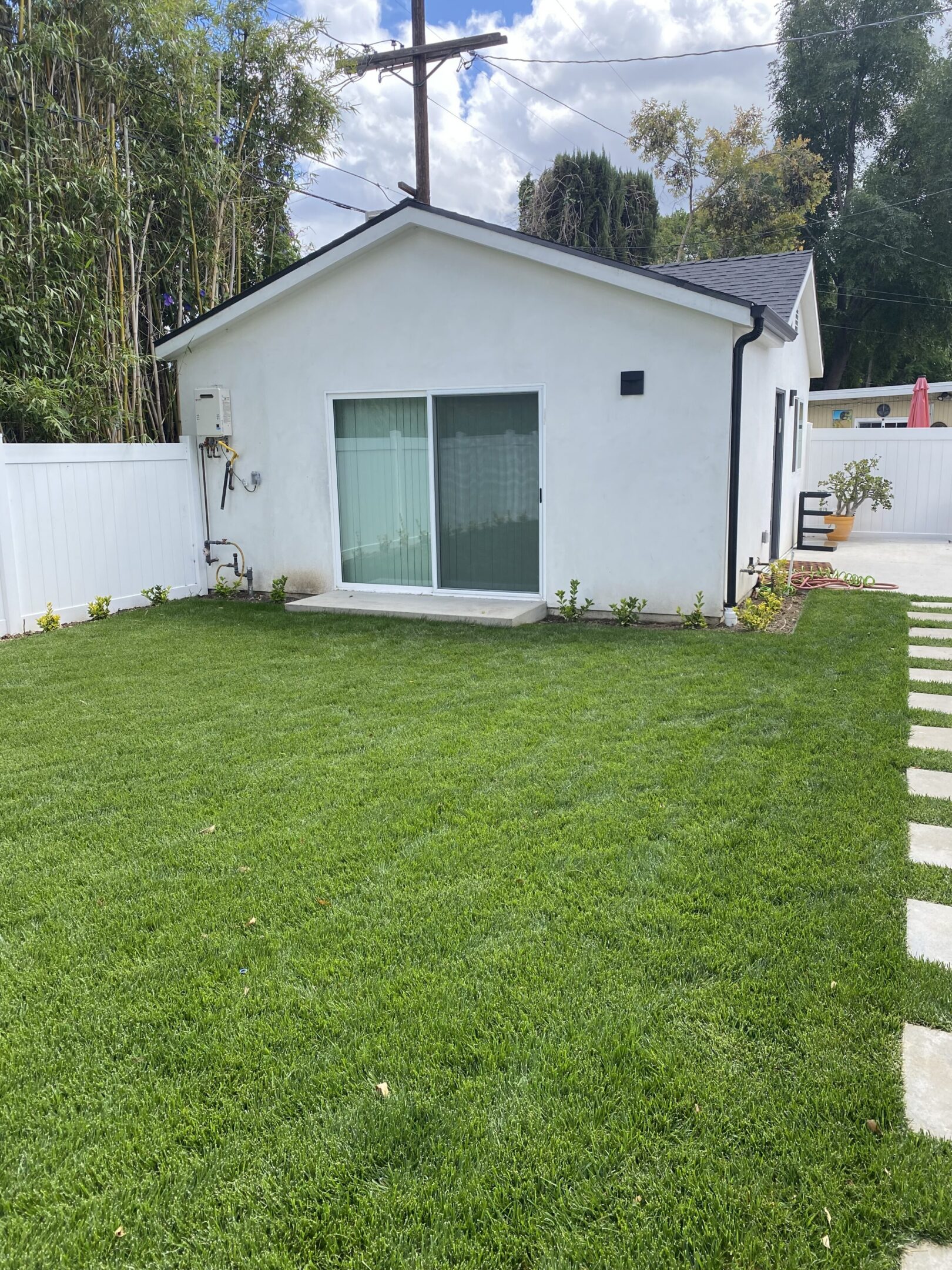 Backyard view with lush green grass.
